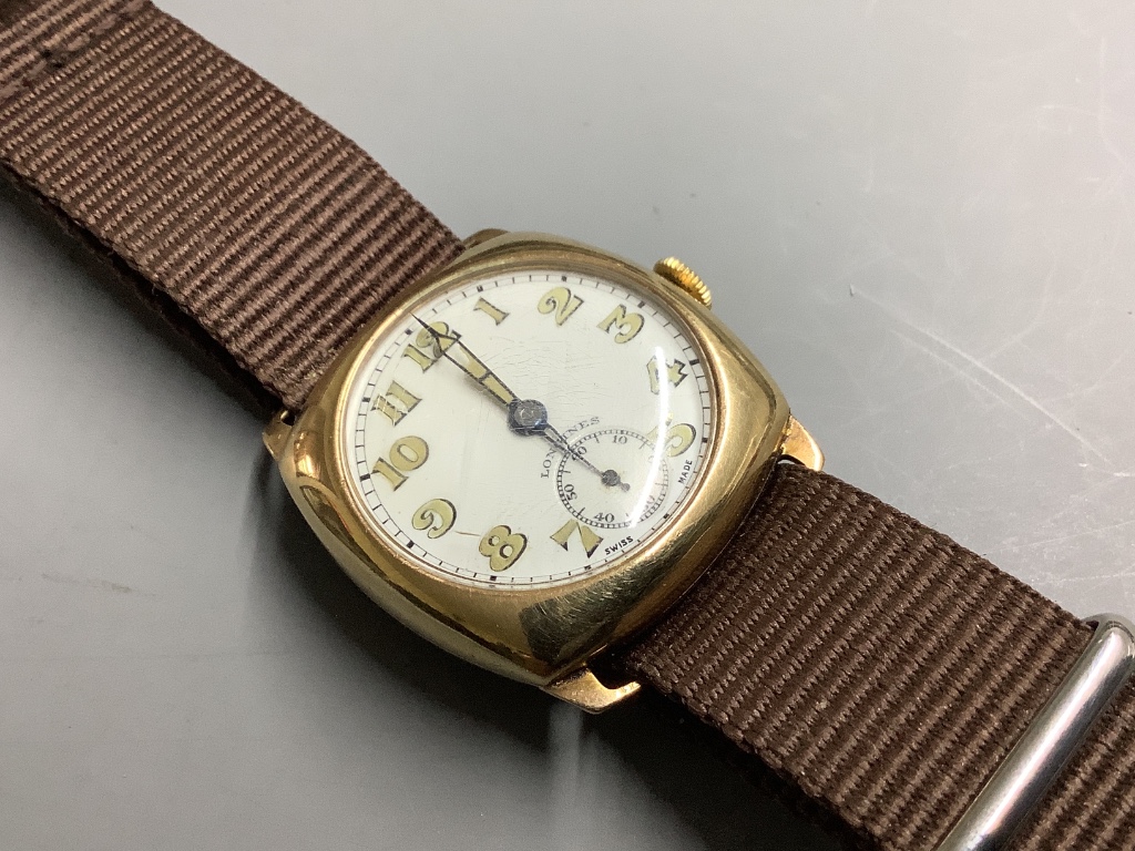 A gentleman's 1940's 9ct gold Longines manual wind wrist watch, with case back inscription, on associated fabric strap